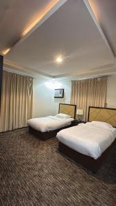 Postel nebo postele na pokoji v ubytování Malfa SERVICED APARTMENTS