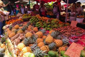 a market with many different fruits and vegetables on display at tite Caz a nou in Saint-Paul