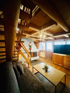 a living room with a couch and a table at Istebna Pełna Chata I in Istebna