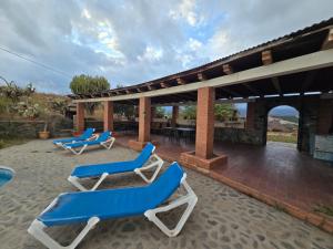 two blue and white lounge chairs on a patio at Cortijo de la luna la casita in Taramay