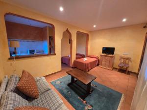 a living room with a couch and a bed at Cortijo de la luna la casita in Taramay
