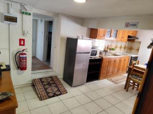 a kitchen with a stainless steel refrigerator and a stove at Jennys Vintage Studio - Motorcycle Friendly in Drama
