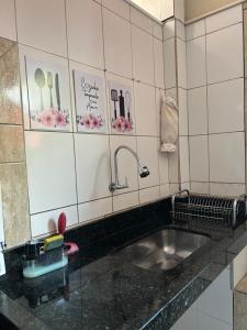 a kitchen counter with a sink and utensils at Refúgio Dom Emanuel in Pirenópolis +50 photos