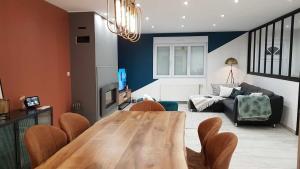 a living room with a wooden table and a couch at House with Outdoor Jacuzzi in Rocroi