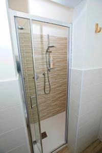 a shower with a glass door in a bathroom at Casanove212 in Casalecchio di Reno