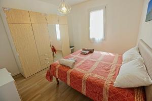 a bedroom with a bed with a red blanket and a cabinet at Casanove212 in Casalecchio di Reno