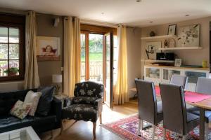 a living room with a couch and a table and chairs at Apartamento Reina de la Paz en San Sebastián de Garabandal in RIonansa