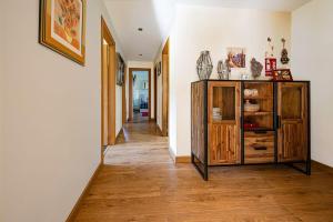 a hallway with a wooden dresser in a house at Apartamento Reina de la Paz en San Sebastián de Garabandal in RIonansa