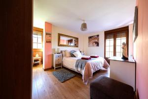 a bedroom with a bed and a dresser in it at Apartamento Reina de la Paz en San Sebastián de Garabandal in RIonansa +25 photos