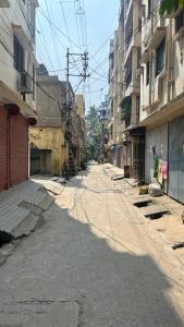 an empty street in a city with tall buildings at Fully furnished 2 BHK Flat in kolkata