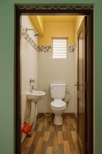 a bathroom with a toilet and a sink at Fully furnished 2 BHK Flat in kolkata