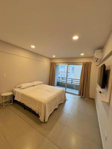 a bedroom with a bed and a television in it at Otero Coliving - Studio Entero U4 in San Salvador de Jujuy