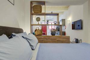 a bedroom with a bed and a window and a television at Charming Rabat Studio Stay in Rabat