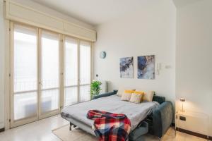 a bedroom with a bed and a large window at La Villa Strangiato in Seregno