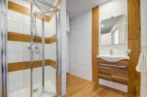 a bathroom with a shower and a sink at Tritoni Alta suites in Il-Gżira +33 photos