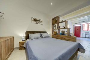 a bedroom with a bed with a blue comforter at Charming Rabat Studio Stay in Rabat