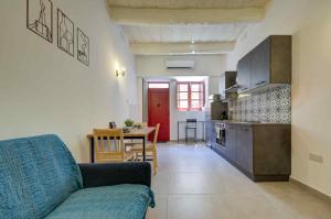 a living room and kitchen with a couch and a table at Charming Rabat Studio Stay in Rabat