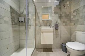 a bathroom with a shower and a toilet and a sink at Charming Rabat Studio Stay in Rabat