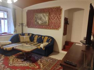 a living room with a couch and a table at Atlantis Apartmán 1 in Klášterec nad Ohří