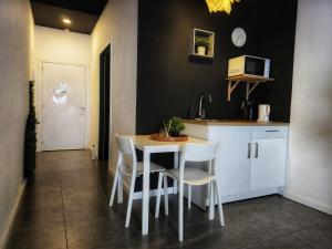a kitchen with a table and some white chairs at Cozy Room G20 in Valencia +11 photos