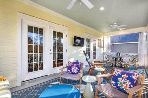 Un porche cubierto con sillas y una mesa. en Cherokee Rose, en Tybee Island