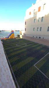 a soccer field in front of a building at Shaleeh 285 شاليه العائلة in Al Khīrān