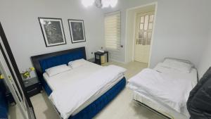 Postel nebo postele na pokoji v ubytování Skynex Apartment