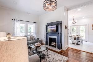 a living room with a couch and a fireplace at Steps to Bryson, walk anywhere downtown! in Bryson City