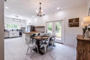 a kitchen and dining room with a table and chairs at Steps to Bryson, walk anywhere downtown! in Bryson City