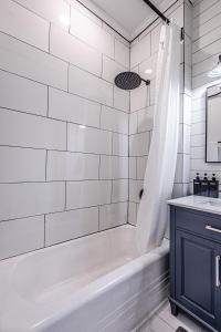 a white bathroom with a tub and a sink at Steps to Bryson, walk anywhere downtown! in Bryson City +47 photos