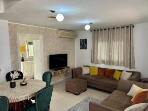 a living room with a couch and a table at Ines House in La Marsa