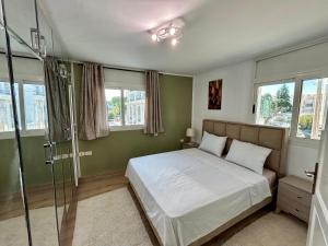 a bedroom with a bed and a glass shower at Ines House in La Marsa