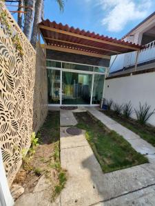 a house with a fence in front of it at Casa Elbatros in Manzanillo