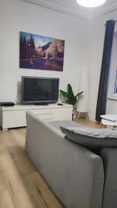 a living room with a couch and a flat screen tv at Appartement 2 chambres avec garage à strasbourg in Strasbourg +17 photos