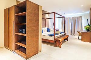 a bedroom with a bed and a desk in a room at Tamala Beach Resort in Kotu