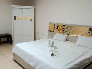 a bedroom with a white bed with towels on it at Siveen Hotel in Amman