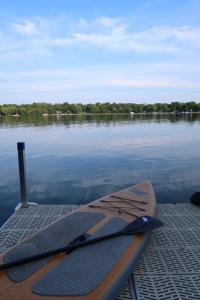 a paddle board sitting on a dock on a body of water at Legacy Lakehouse in Spicer