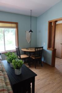 a living room with a table and a dining room at Legacy Lakehouse in Spicer