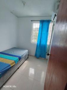 a small room with a bed and a window at Blue Pearl Cartagena in Cartagena de Indias