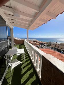 a balcony with a table and chairs and the ocean at Loft Sofi in Morro del Jable