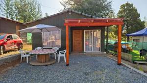 a patio with a table and an umbrella at Refugio Vilches in Vilches