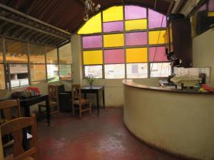 a room with stained glass windows and a bar at Coca Runa Wasi Hostel in Pisac +28 photos