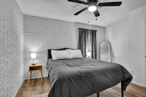 a bedroom with a bed and a ceiling fan at Near Boomer Lake & OSU - Relaxing Retreat in Stillwater