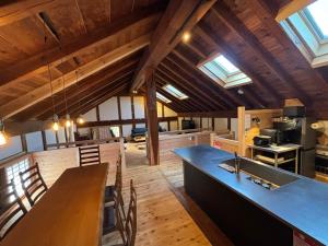 a large kitchen with a large blue counter in a cabin at 離れの宿 かぶろの庭 in Matsukawa