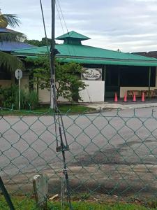 a fence in front of a building with orange cones at HomestayFA in Gua Sai +4 photos