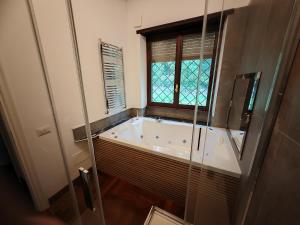 a bath tub in a bathroom with a window at Blue emotion, into wellness & wilderness in Albano Laziale +19 photos