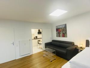 a living room with a couch and a bedroom at Anacoco Suites in Würselen +62 photos