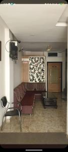 a living room with a couch and a tv at Hotel Grande Inn in Udaipur