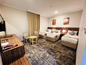 Postel nebo postele na pokoji v ubytování فندق الريادة جراند