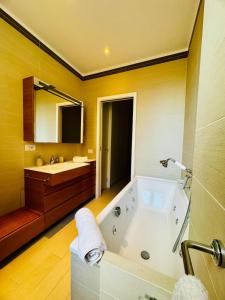 a large bathroom with a tub and a sink at Borgo Pio Suite Apartment in Rome +32 photos
